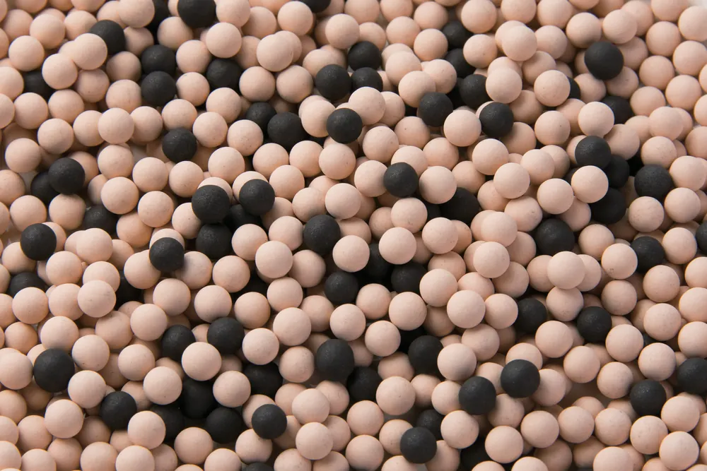The peach and charcoal ceramic mineral spheres inside the ANESPA DX